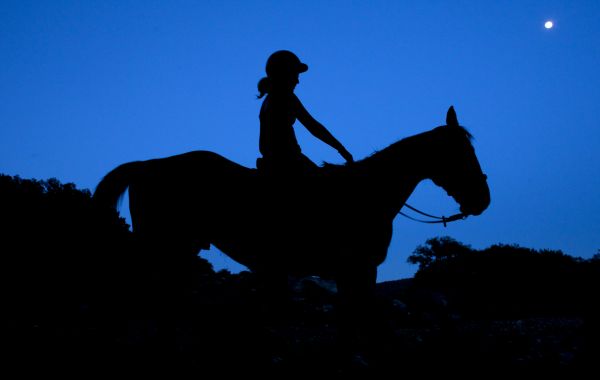 Horseback riding with a full moon